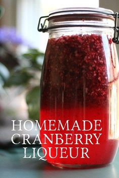 a jar filled with cranberry liqueur sitting on top of a table