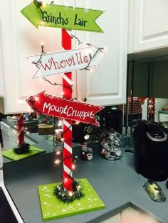 a kitchen counter topped with christmas decorations and street signs that read, which way to the mout crump?