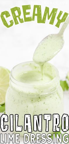 a jar filled with cream sitting on top of a table next to lemons and lime slices