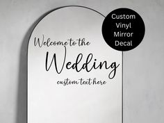 a mirror with the words welcome to the wedding written on it and a black circle