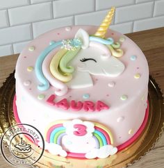 a birthday cake with a unicorn on top