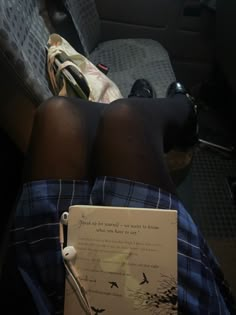 the person is laying down with their legs crossed and holding a book in his lap