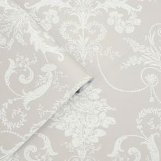 a white wallpaper with an intricate design on it