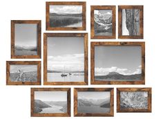 a bunch of pictures hanging on the wall with some wood frames around them that have boats and mountains in black and white