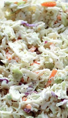 a close up view of a coleslaw salad with carrots and celery