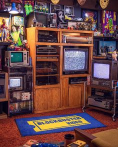 a living room filled with lots of old tvs