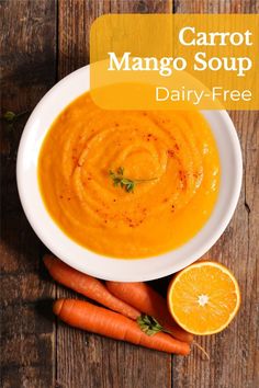 carrot soup in a white bowl surrounded by sliced oranges