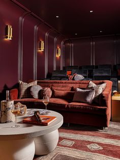 a living room filled with furniture and a wine glass on top of a coffee table