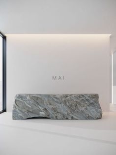 a stone bench sitting in the middle of a room