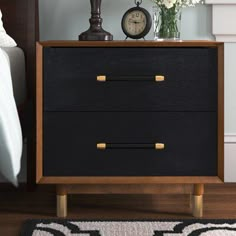 A study in design depth, this nightstand is a showstopper. A walnut-finished frame provides a stunning contrast to its brass-capped legs and pulls, giving Justice a distinct couturier look. Everly Quinn Color: Walnut/Black | Everly Quinn Gleavy 2 - Drawer Nightstand 22.0 H x 23.0 W x 16.0 D in black / brownWood in Walnut / Black | 22" H X 23" W X 16" D | Wayfair Nightstand Black, Nightstand Wood, Black Nightstand, Primary Bedroom, 2 Drawer Nightstand, Furniture Renovation, Wood Nightstand, Master Bedrooms Decor