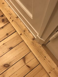 wood flooring is being installed on the side of a door