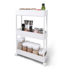 a white shelf with spices and containers on it's bottom shelf, against a white background