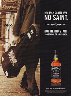 an advertisement for jack daniels whiskey with a man holding a guitar case