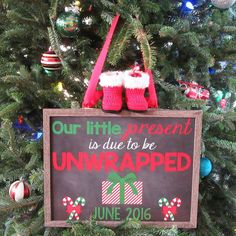 a christmas tree with a sign that says our little present is due to be unwrapped