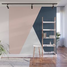 a living room with a blue and gray wall mural on the wall next to a wooden floor