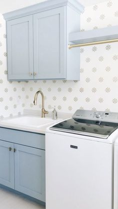 a kitchen with blue cabinets and white appliances