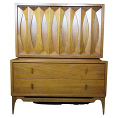 an art deco dresser with two drawers and one drawer on the bottom, is made out of wood