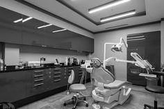 a dentist's office with dental equipment in black and white