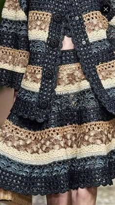 a close up of a woman's dress with crochet on the skirt