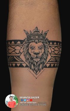 a lion with a crown tattoo on his leg