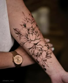 a woman's arm with flowers on it