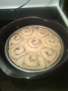 a pan filled with food sitting on top of a stove