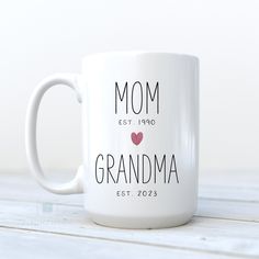 a white coffee mug with the words, mom est 1970 and grandma est 2013 printed on it