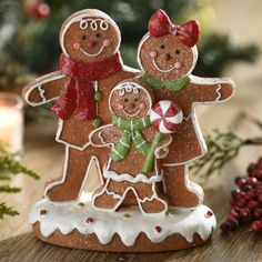 two gingerbread man and woman standing next to each other