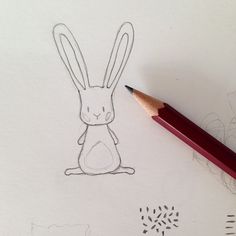 a pencil drawing of a rabbit sitting on the ground