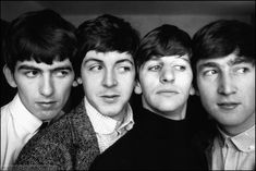 the beatles are posing for a black and white photo