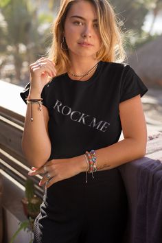 Express your love for rock music with this Trini Skies graphic T-shirt.  The solid pattern, crew neckline, and pullover closure make this shirt a must-have for any woman's wardrobe. The short sleeves provide a relaxed, comfortable fit that is perfect for all seasons.  This style T-shirt is perfect for amplifying your personal style. The shirt is suitable for casual outings, concerts, and other events. Show off your love for classic rock music with this trendy and comfortable T-shirt. Rock Style Crew Neck T-shirt For Streetwear, Rock Style Crew Neck T-shirt With Screen Print, Rock Style T-shirt With Letter Print And Short Sleeves, Edgy Sublimation Print Top For Concerts, Edgy Crew Neck T-shirt For Concert, Rock Style Crew Neck T-shirt With Letter Print, Edgy T-shirt With Sublimation Print And Crew Neck, Edgy Crew Neck T-shirt With Sublimation Print, Summer Rock Style Streetwear T-shirt