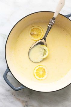 lemons are being cooked in a pan with a spoon