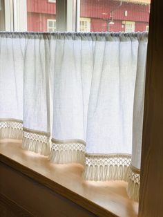 the curtains are hanging on the window sill in front of the windowsills