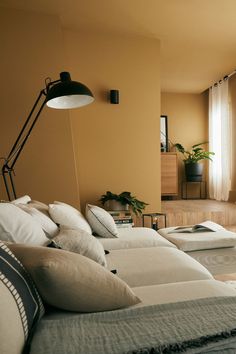 a living room filled with lots of furniture and pillows