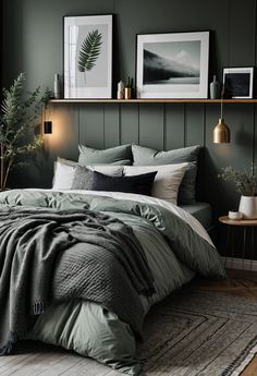 a bed with green sheets and pillows in a room next to two pictures on the wall