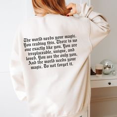 a woman wearing a white sweatshirt with writing on the front and back of her jacket