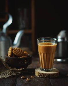 a cup of coffee sitting on top of a wooden table