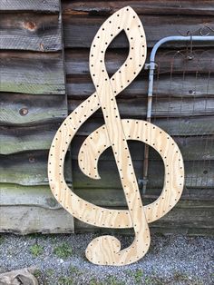 a wooden treble sitting next to a wall