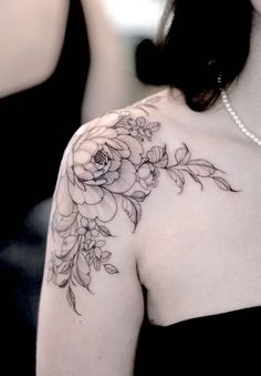 a woman with a flower tattoo on her shoulder