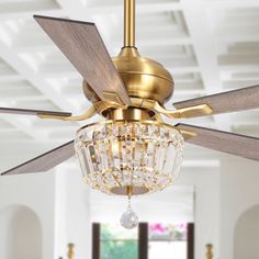 a gold ceiling fan with crystal chandelier hanging from it's center point