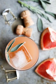 an overhead view of a drink with grapefruit and rosemary garnish