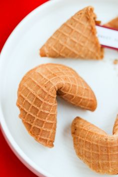 three pieces of food on a plate with a name tag in the middle and one piece missing