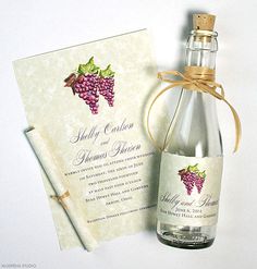 a bottle of wine next to a paper with a label on it and an envelope