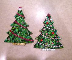 two christmas trees made out of green and red mosaic tiles