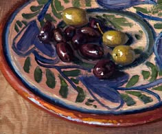 an oil painting of olives on a plate