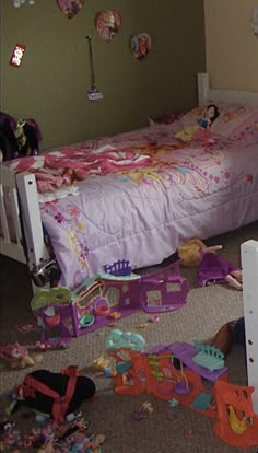 a child's bedroom with toys all over the floor