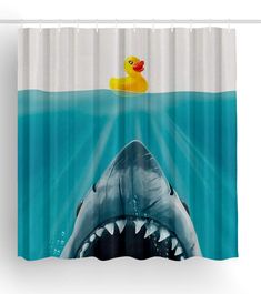 a shower curtain with an image of a shark and rubber duck floating in the water