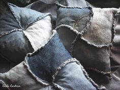 four pillows with ruffled edges on top of each other in blue and grey colors