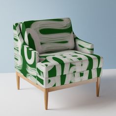 a green and white chair sitting on top of a table