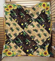 a quilt made to look like a farm scene with tractors and sunflowers on it